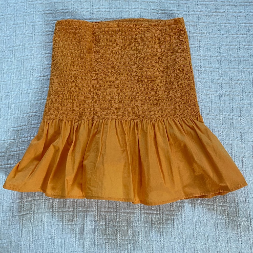 Orange peplum ruffle mini skirt.